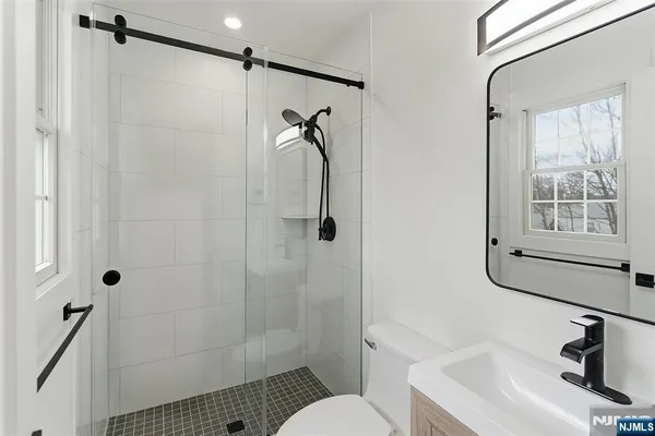 a bathroom with a sink toilet and shower