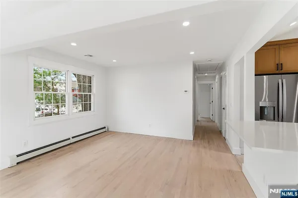 a view of a kitchen with a sink and refrigerator
