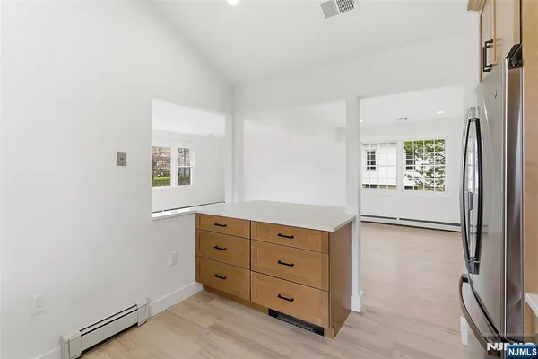 a room with a dresser and a window