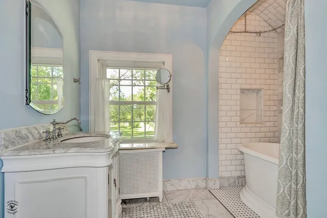 a bathroom with a sink a toilet and window