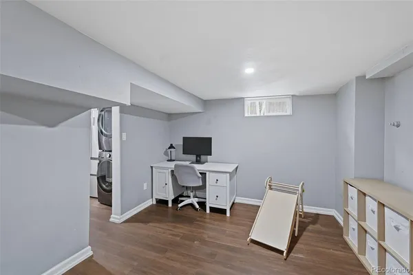a bedroom with a large bed and wooden floor