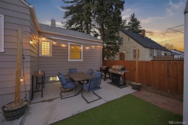 a view of house with backyard and parking