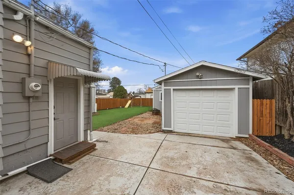 a backyard of a house with table and chairs