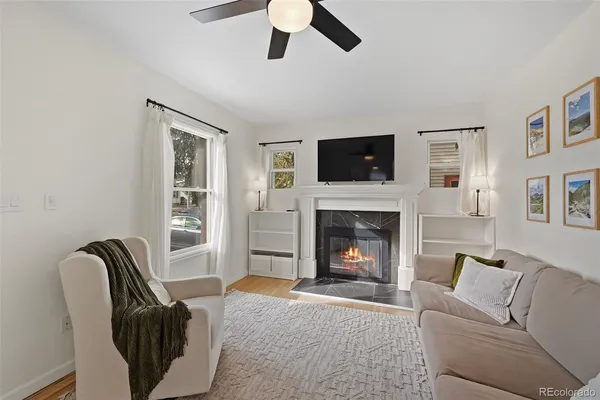a living room with furniture and a wooden floor