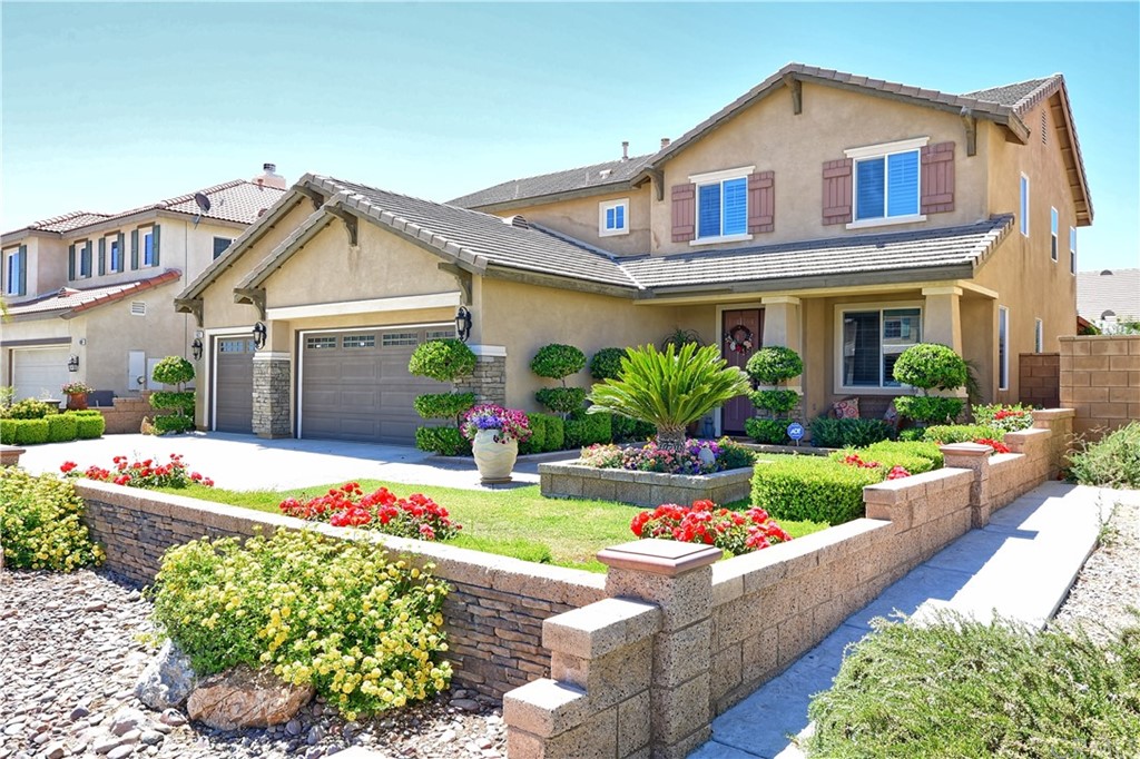 11823 Nyack Road Victorville, CA 92392 - Photo 1 of 1 a front view of a house with a garden