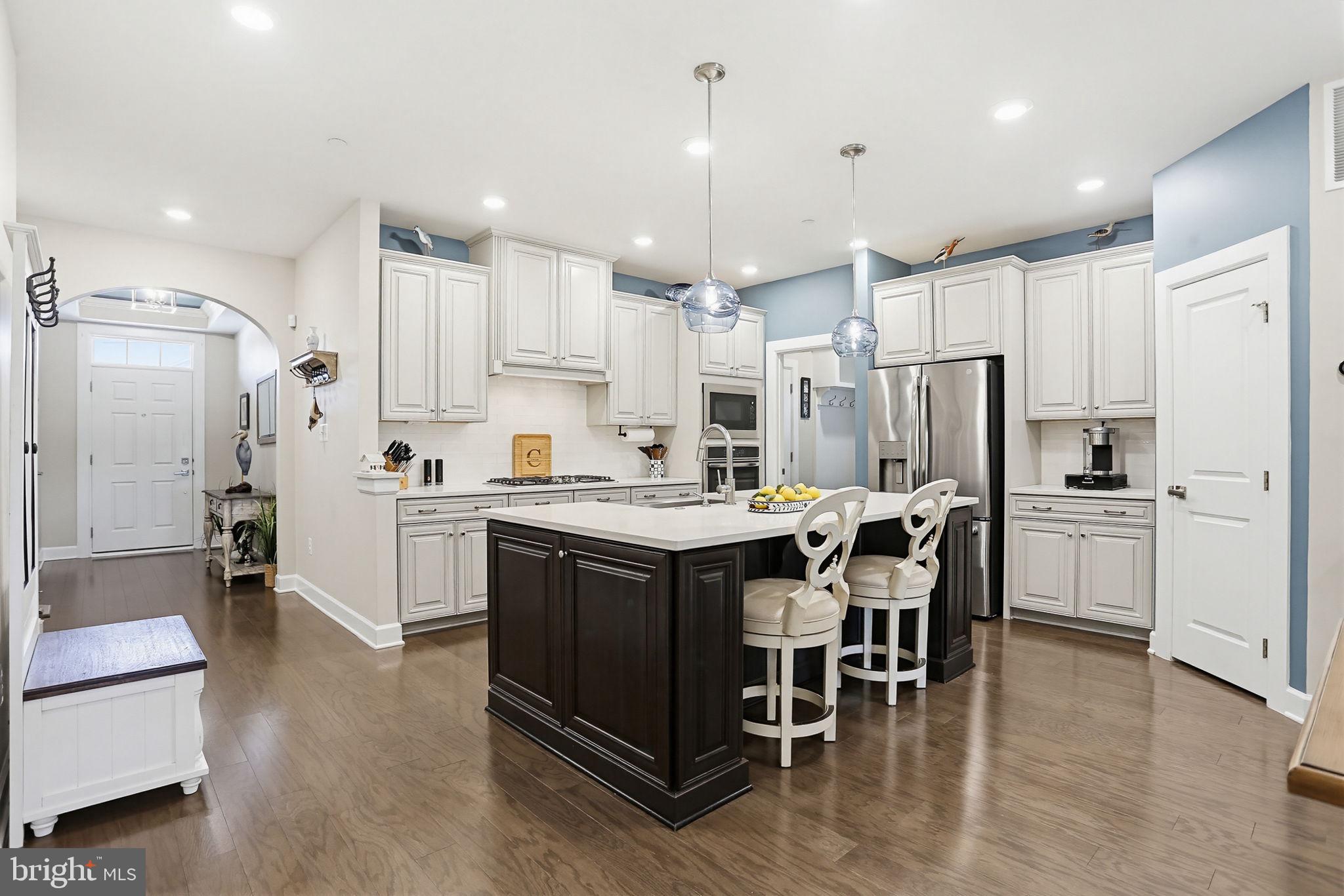 3816 Fulham Road Frederick, MD 21704 - Photo 13 of 77 a kitchen with kitchen island wooden cabinets and refrigerator