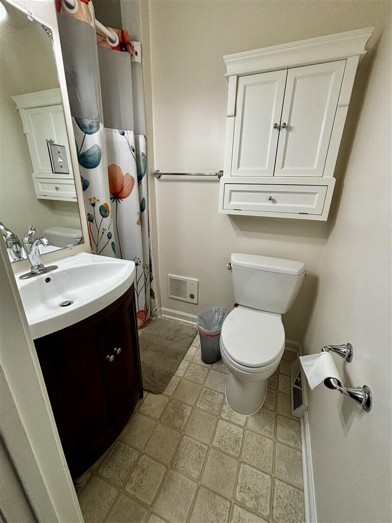 1032 Windy Ridge Drive Bedford, VA 24523 - Photo 14 of 27 a bathroom with a toilet sink and mirror