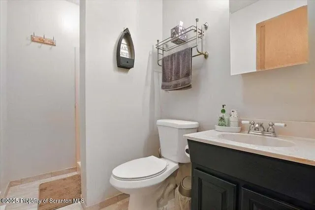 a bathroom with a sink toilet and vanity