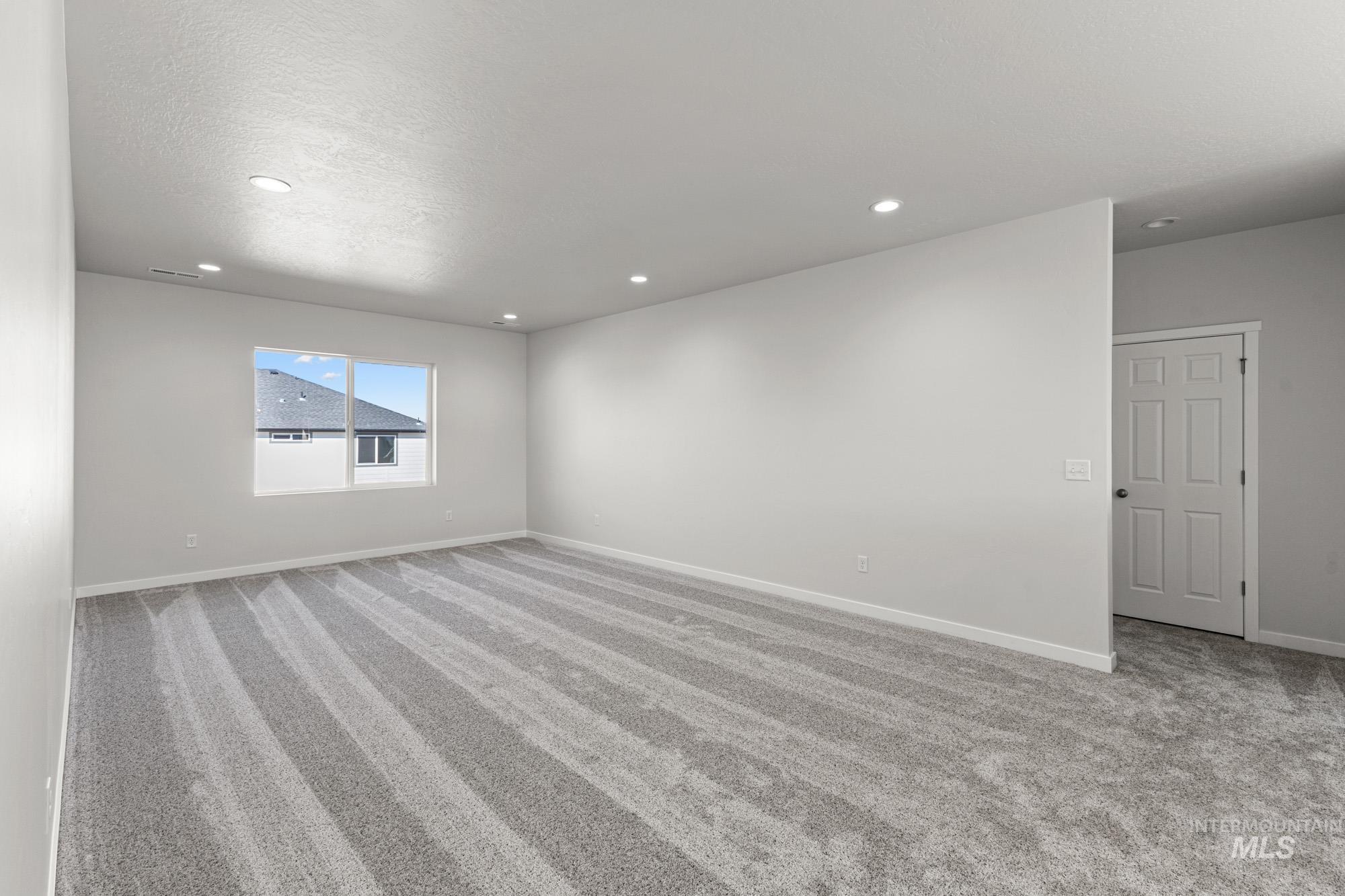 13708 Judson Street Caldwell, ID 83607 - Photo 16 of 29 Spare room with light colored carpet and recessed lighting