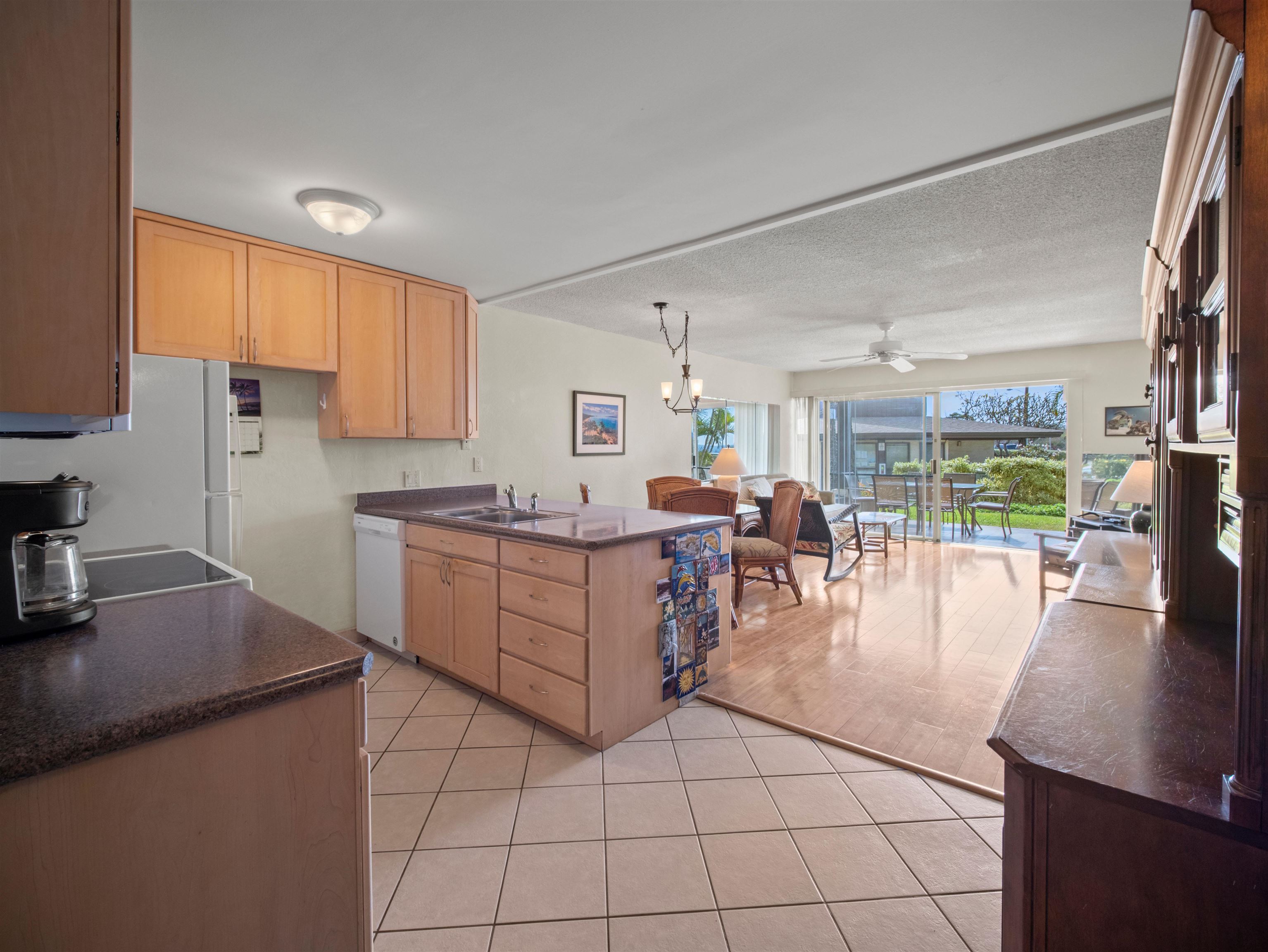 2737 South Kihei Road, Unit 1106 Kihei, HI 96753 - Photo 13 of 25 a kitchen with a sink cabinets and wooden floor