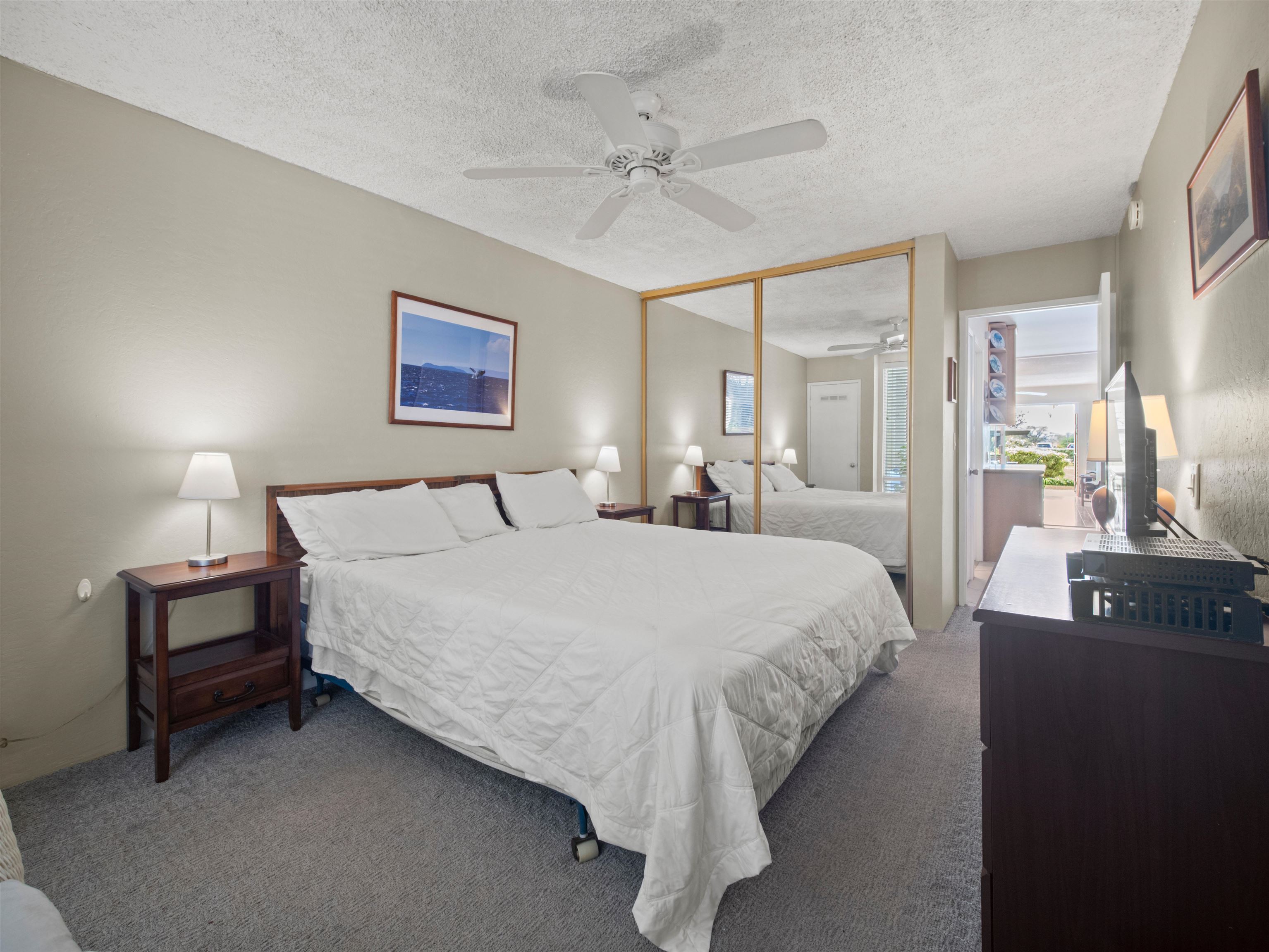 2737 South Kihei Road, Unit 1106 Kihei, HI 96753 - Photo 16 of 25 a bed room with a bed and a night stand