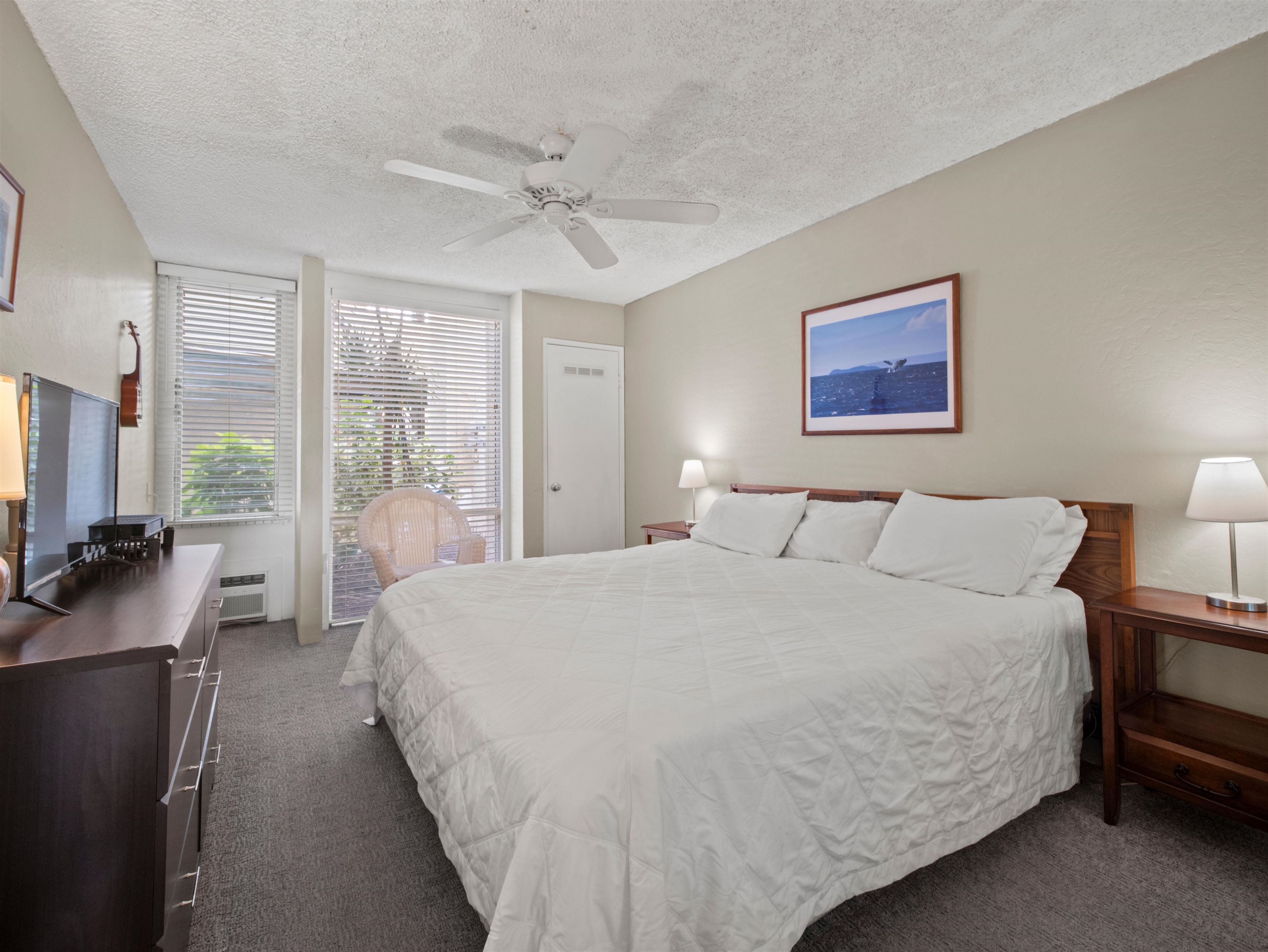 2737 South Kihei Road, Unit 1106 Kihei, HI 96753 - Photo 17 of 25 a spacious bedroom with a bed a couch and large window