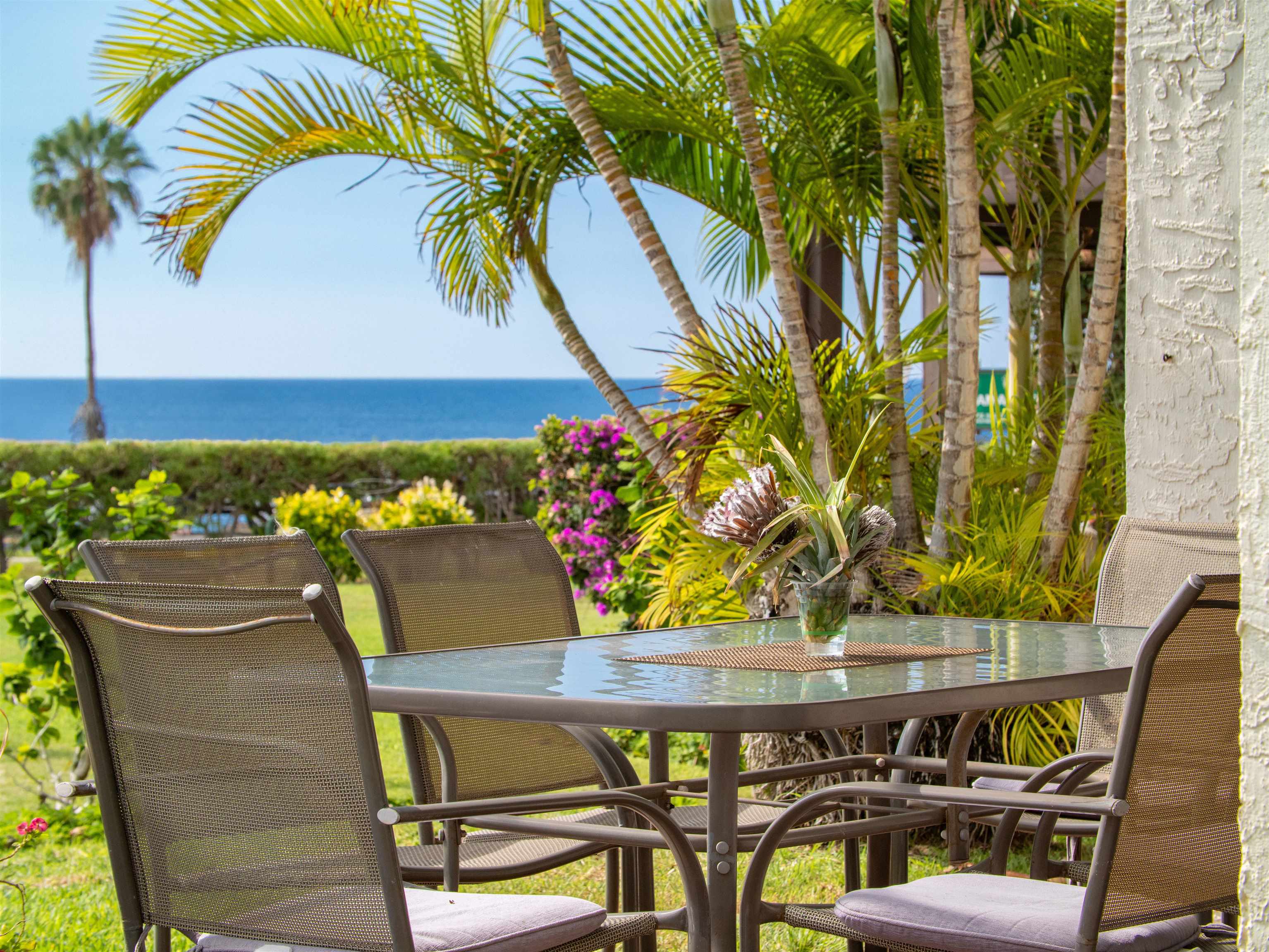 2737 South Kihei Road, Unit 1106 Kihei, HI 96753 - Photo 2 of 25 a view of an outdoor dining space with a table and chairs