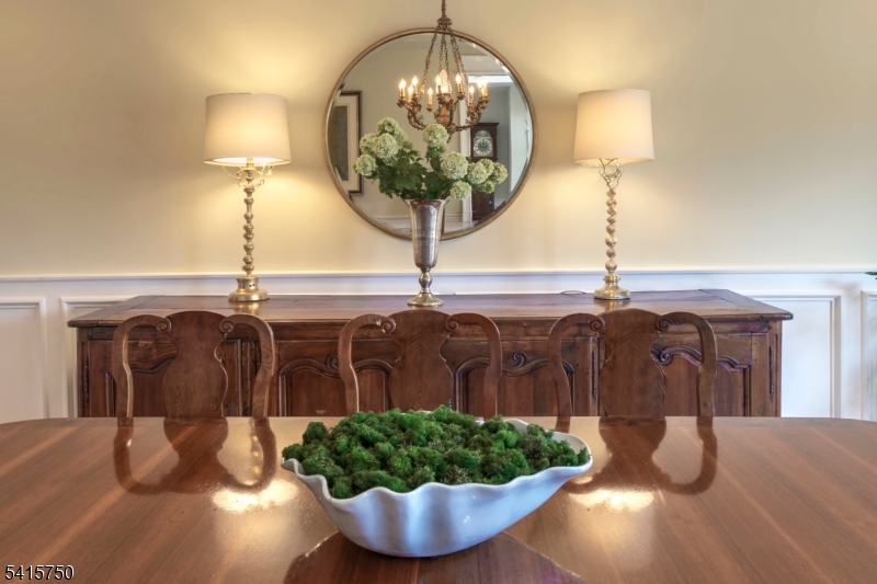 85 Mosle Road Peapack-Gladstone, NJ 07931 - Photo 11 of 49 a vase of flowers sitting on a table with chandelier