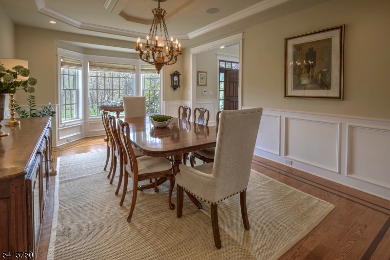 85 Mosle Road Peapack-Gladstone, NJ 07931 - Photo 12 of 49 a dining room with furniture a chandelier and wooden floor