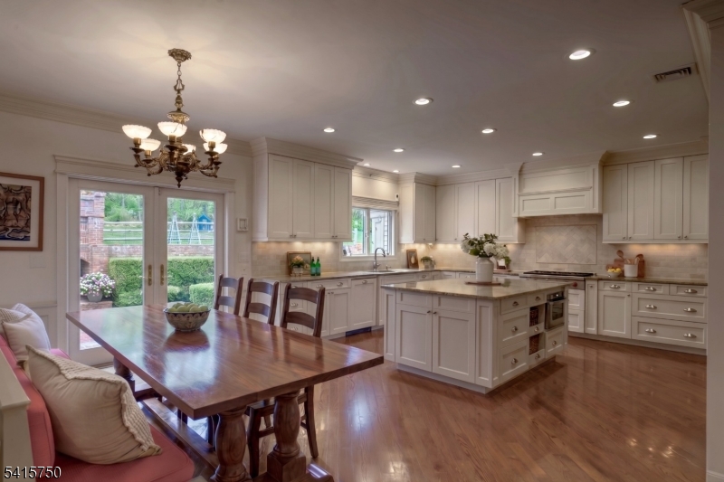 85 Mosle Road Peapack-Gladstone, NJ 07931 - Photo 22 of 49 a kitchen with counter space dining table and chairs