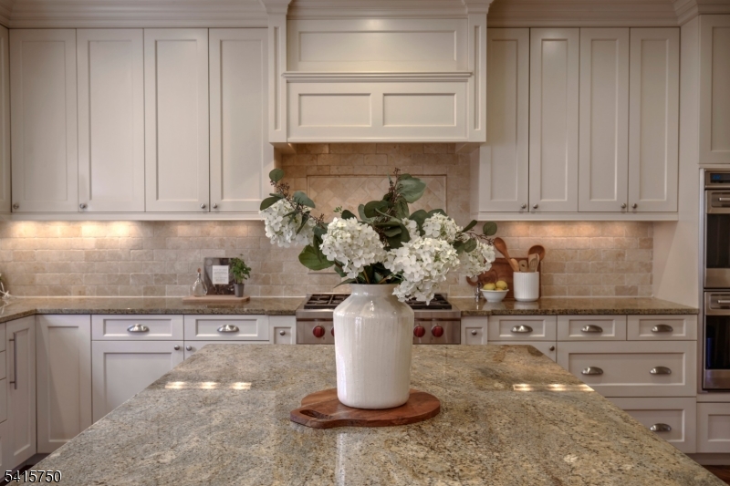 85 Mosle Road Peapack-Gladstone, NJ 07931 - Photo 25 of 49 a kitchen with a stove and cabinets