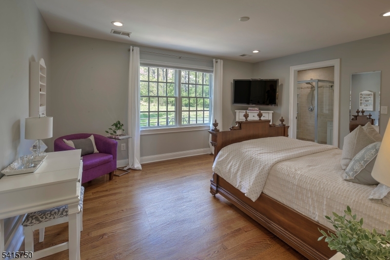 85 Mosle Road Peapack-Gladstone, NJ 07931 - Photo 34 of 49 a spacious bedroom with a bed and a flat screen tv