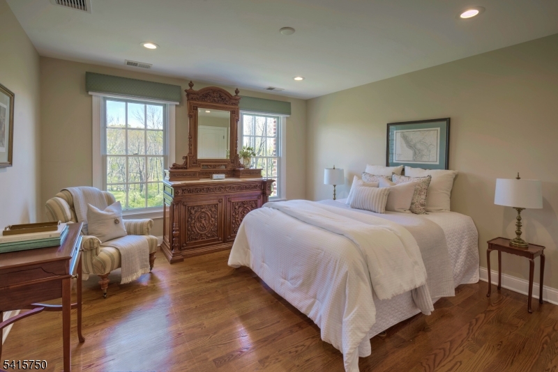 85 Mosle Road Peapack-Gladstone, NJ 07931 - Photo 36 of 49 a bedroom with a bed and wooden floor