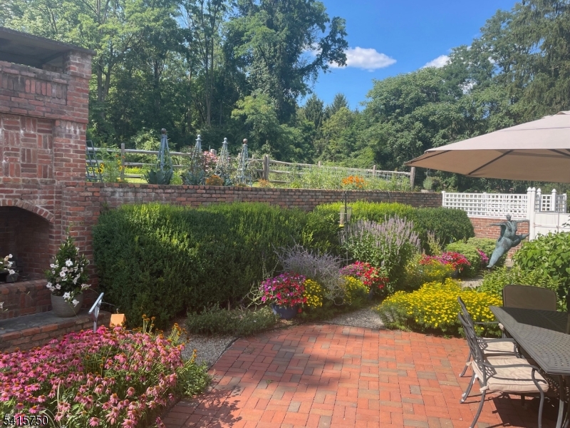 85 Mosle Road Peapack-Gladstone, NJ 07931 - Photo 46 of 49 a view of a garden with plants and large trees