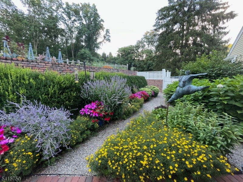 85 Mosle Road Peapack-Gladstone, NJ 07931 - Photo 48 of 49 a front view of a house with lots of flower and trees