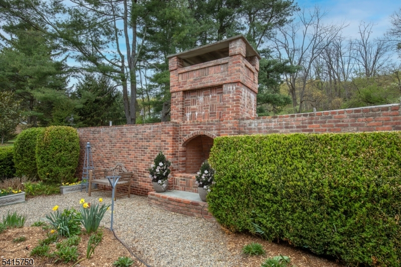 85 Mosle Road Peapack-Gladstone, NJ 07931 - Photo 49 of 49 a backyard of a house with lots of green space and fountain