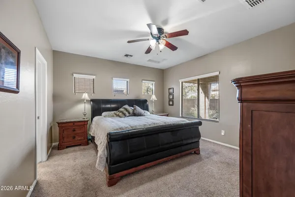 a kitchen with a table chairs microwave and cabinets