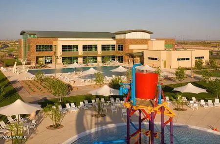 a view of a backyard with potted plants and a large tree