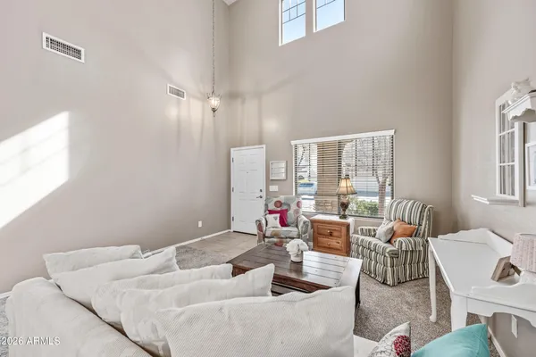 a view of a dining room with furniture and chandelier