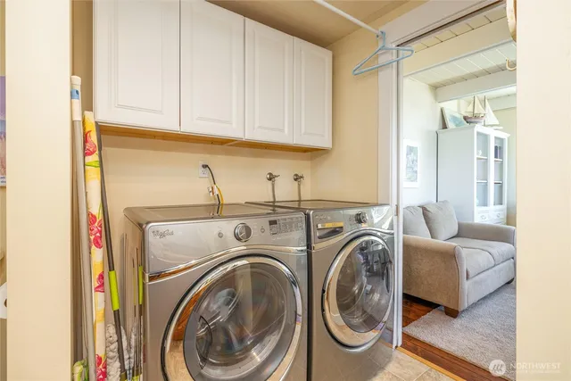 a kitchen with a refrigerator sink and cabinets