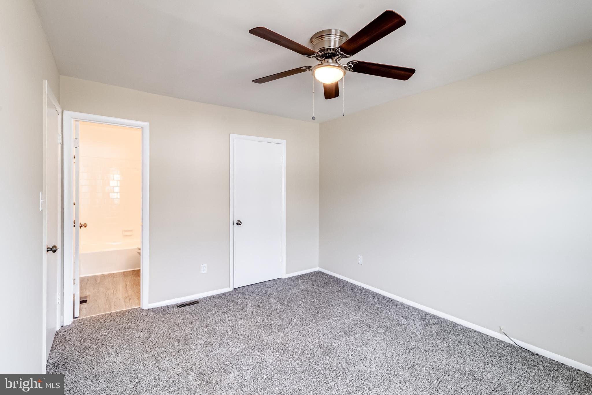 982 Topview Drive Edgewood, MD 21040 - Photo 15 of 25 an empty room with a chandelier fan and windows