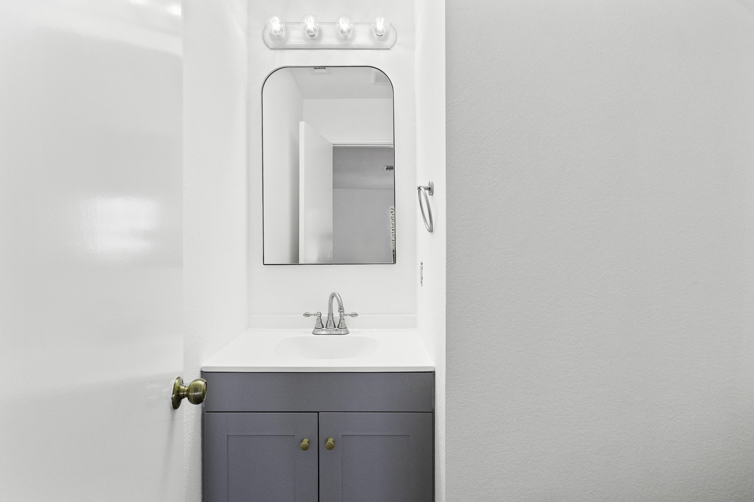 2431 Lavendale Court Austin, TX 78748 - Photo 12 of 22 Downstairs powder room featuring new vanity, LVP flooring, hardware, mirror and toilet.