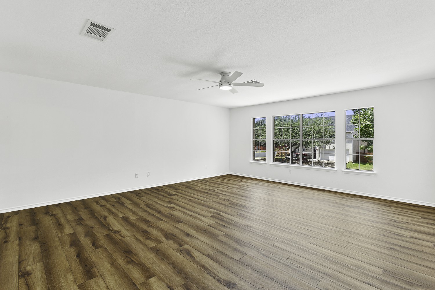 2431 Lavendale Court Austin, TX 78748 - Photo 13 of 22 Large freshly painted primary bedroom with lots of natural light, new LVP flooring and ceiling fan.