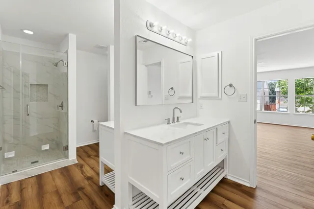 a bathroom with a sink a toilet and shower