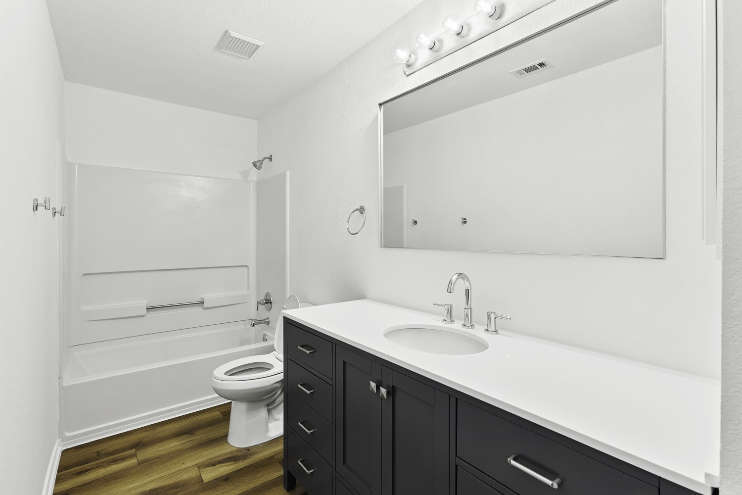 2431 Lavendale Court Austin, TX 78748 - Photo 21 of 22 Freshly painted full bathroom featuring a new vanity, mirror, hardware, toilet and LVP flooring