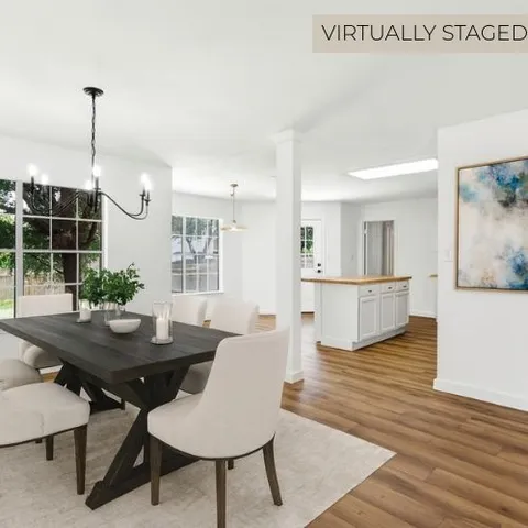a view of a dining room with furniture and wooden floor