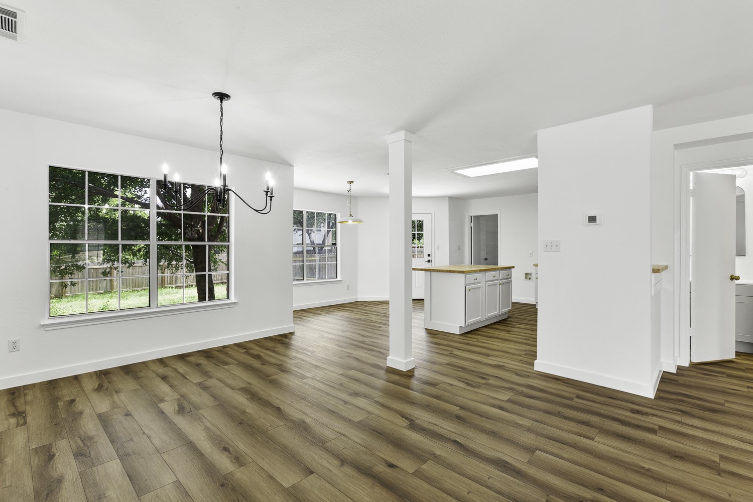 2431 Lavendale Court Austin, TX 78748 - Photo 7 of 22 Open concept living, dining and kitchen. Featuring new LVP flooring, lighting and island.