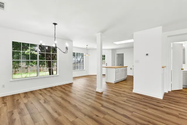 a view of empty room with wooden floor and outdoor view