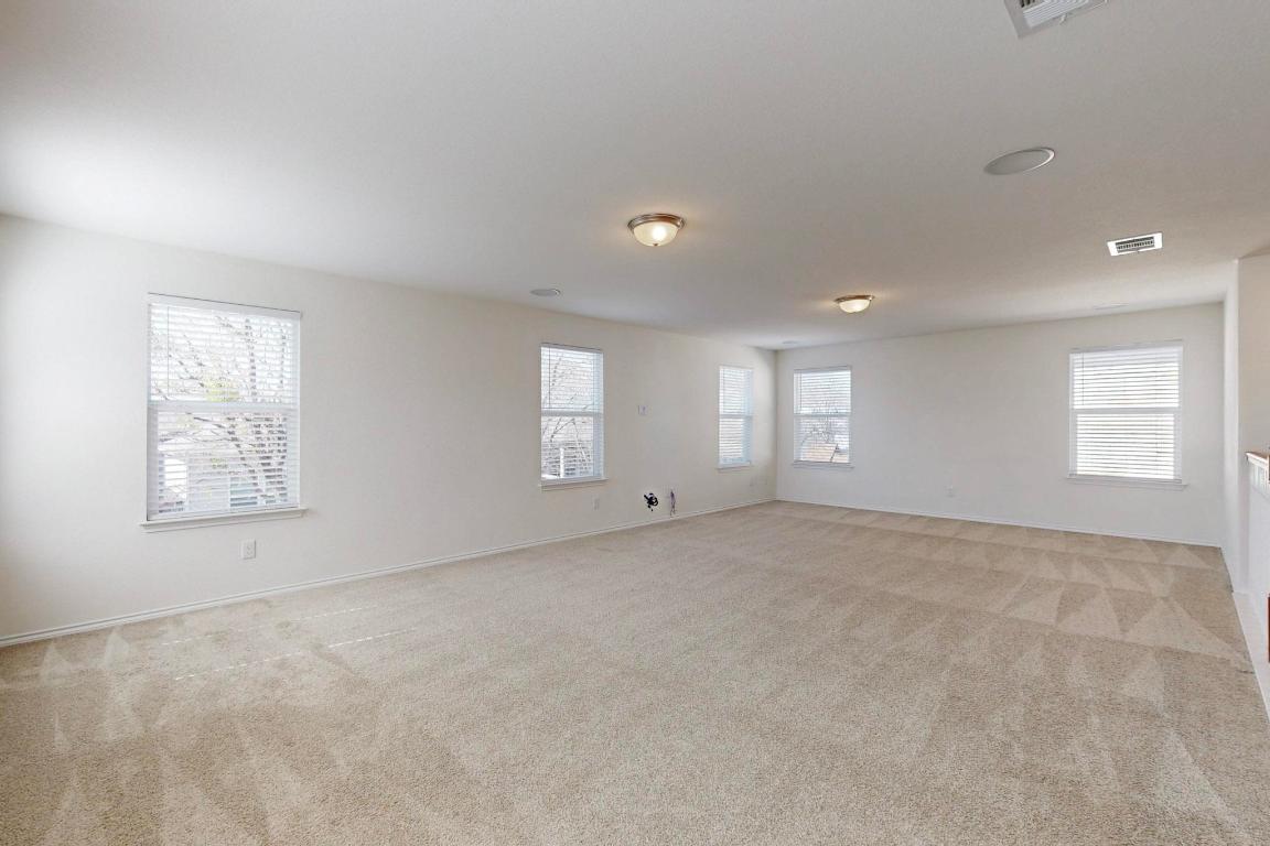17308 Crazy Arm Road Round Rock, TX 78664 - Photo 12 of 22 a view of an empty room with windows