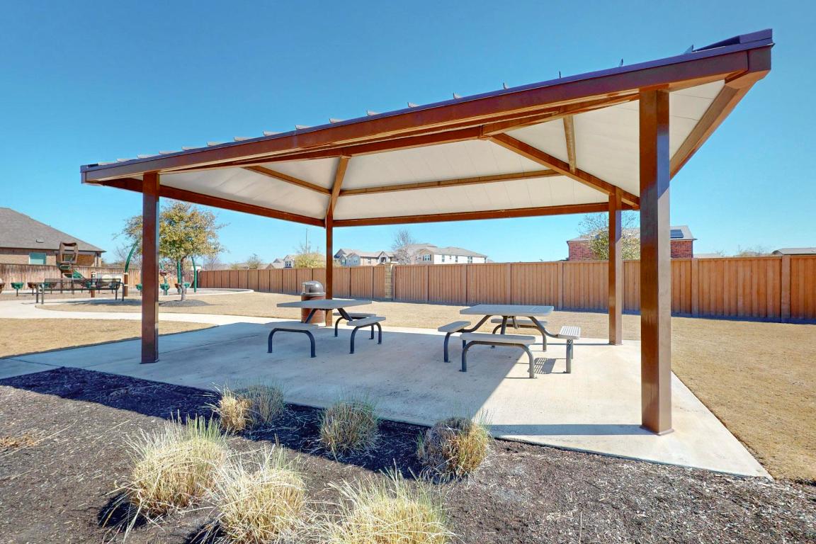 17308 Crazy Arm Road Round Rock, TX 78664 - Photo 20 of 22 a view of a patio with a table and chairs
