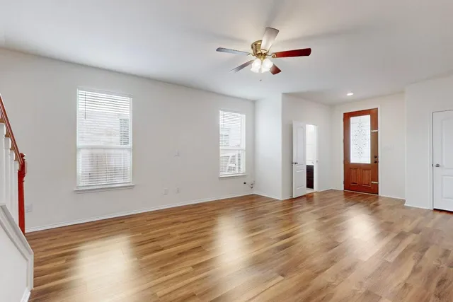 a view of an empty room with wooden floor
