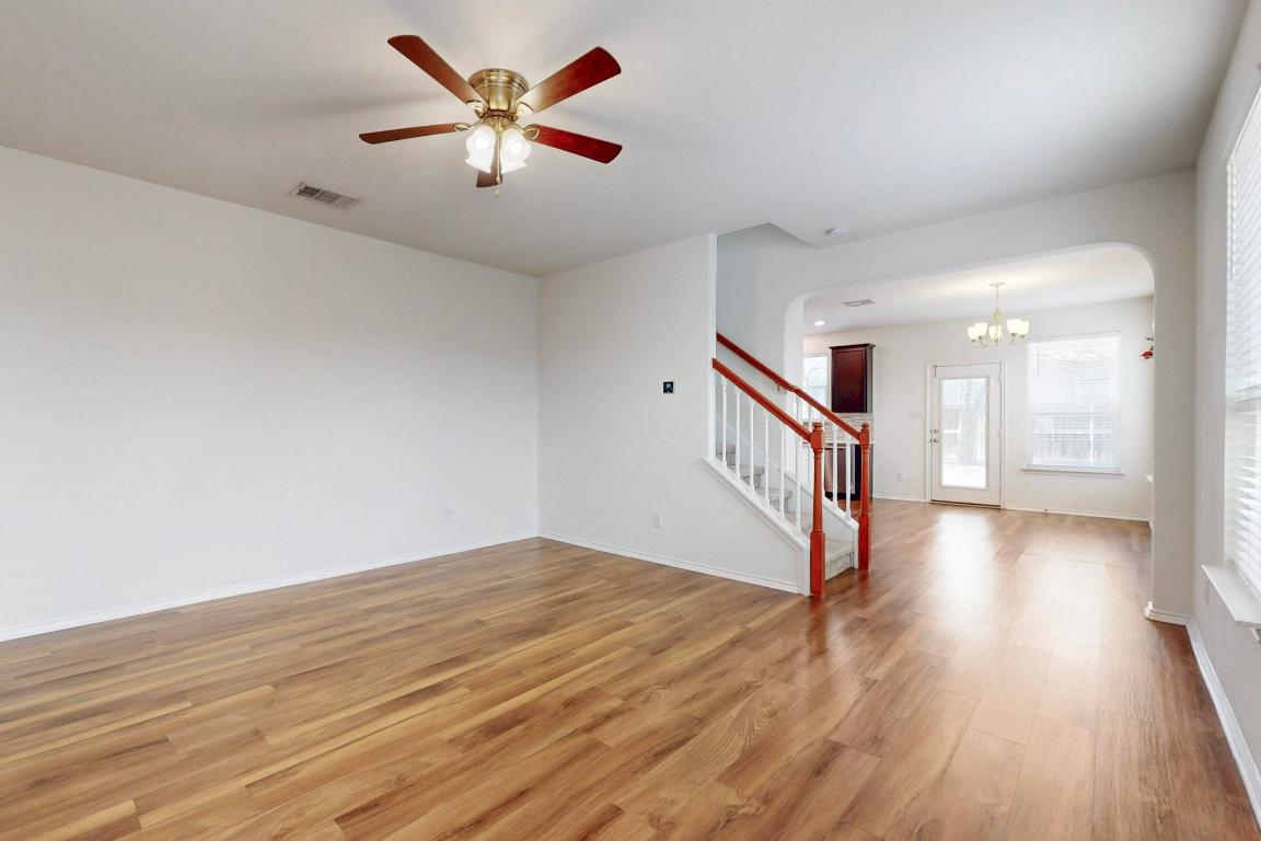 17308 Crazy Arm Road Round Rock, TX 78664 - Photo 4 of 22 a view of an empty room with wooden floor