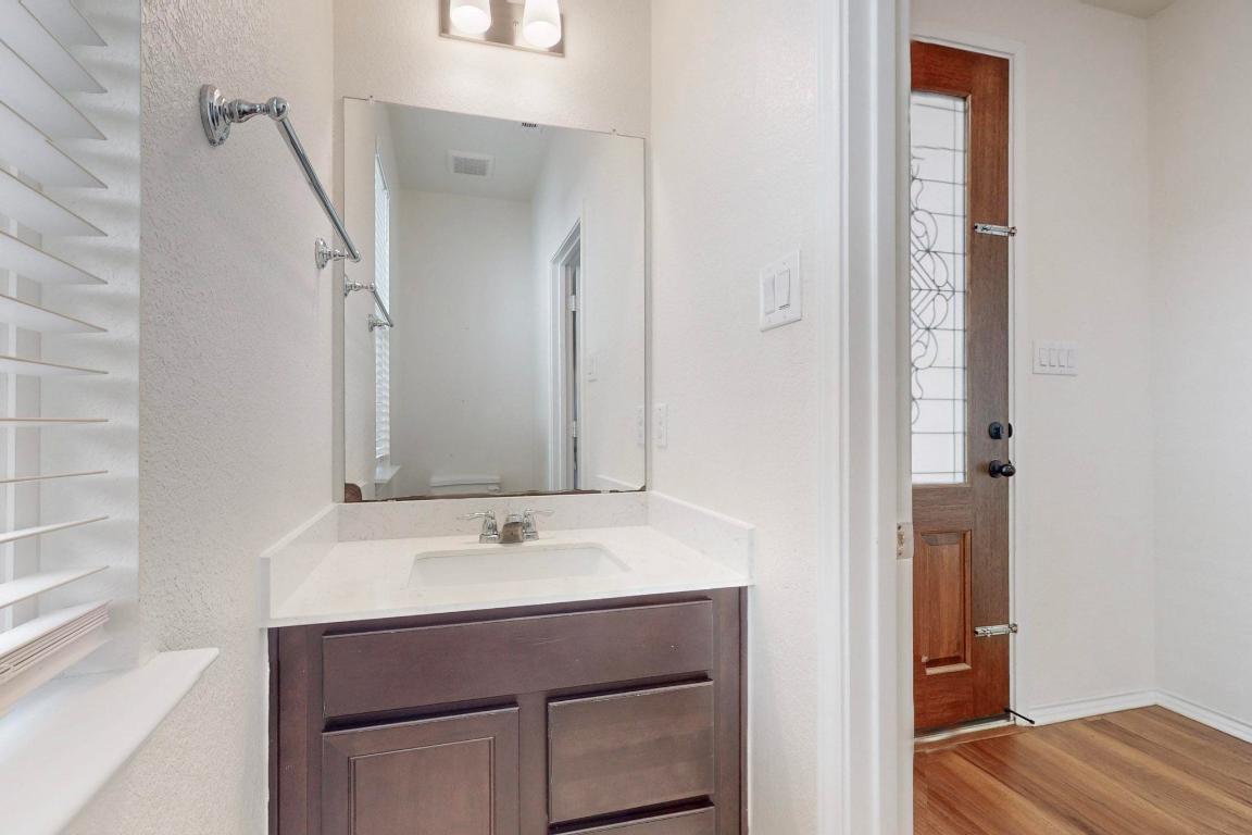 17308 Crazy Arm Road Round Rock, TX 78664 - Photo 8 of 22 a bathroom with a sink vanity and a mirror