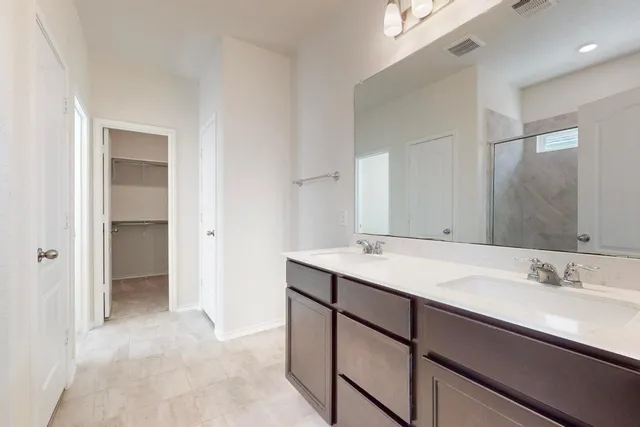 a bathroom with a glass shower door