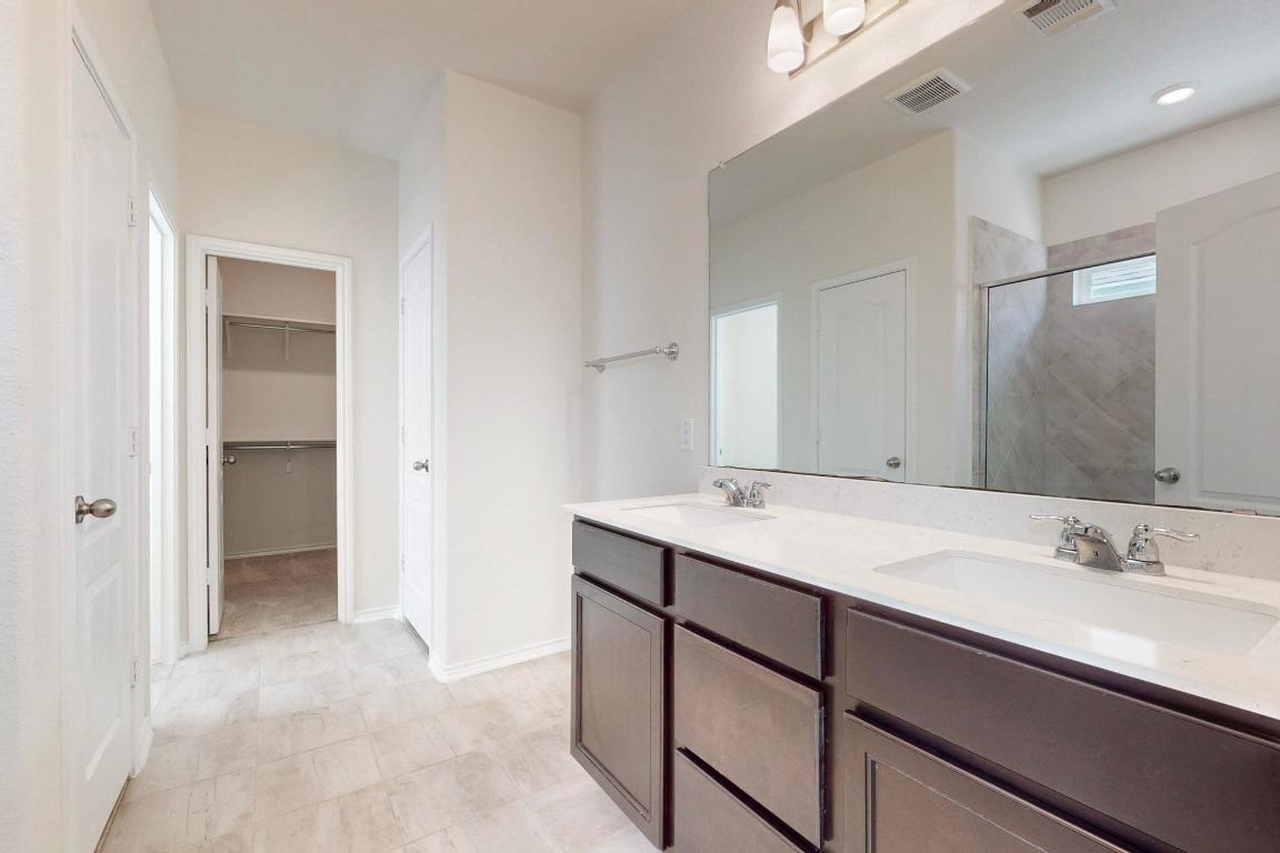 17308 Crazy Arm Road Round Rock, TX 78664 - Photo 10 of 22 a bathroom with a sink and a mirror