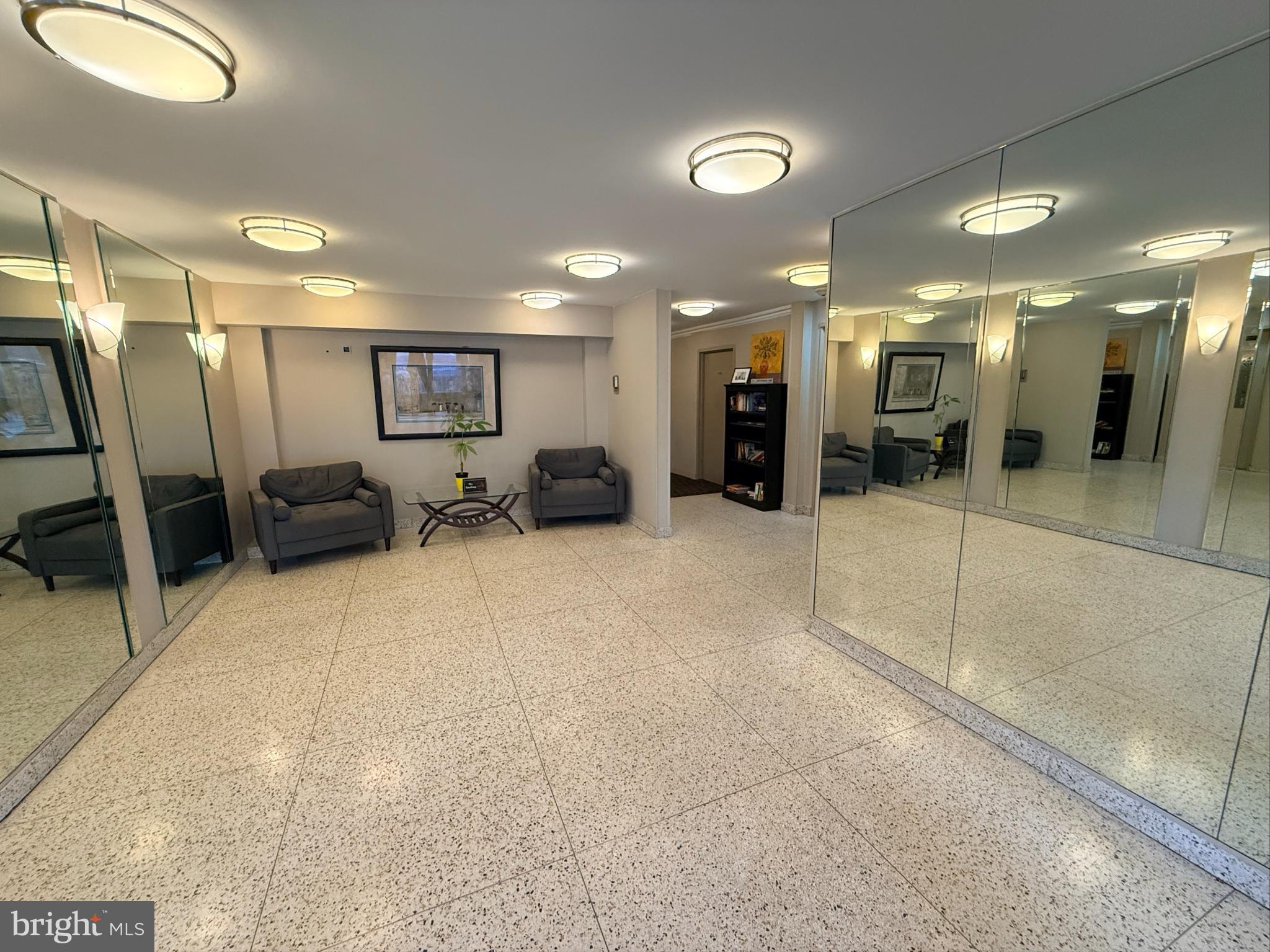 575 Thayer Avenue, Unit 703 Silver Spring, MD 20910 - Photo 2 of 9 Spacious lobby with elegant mirrored walls.