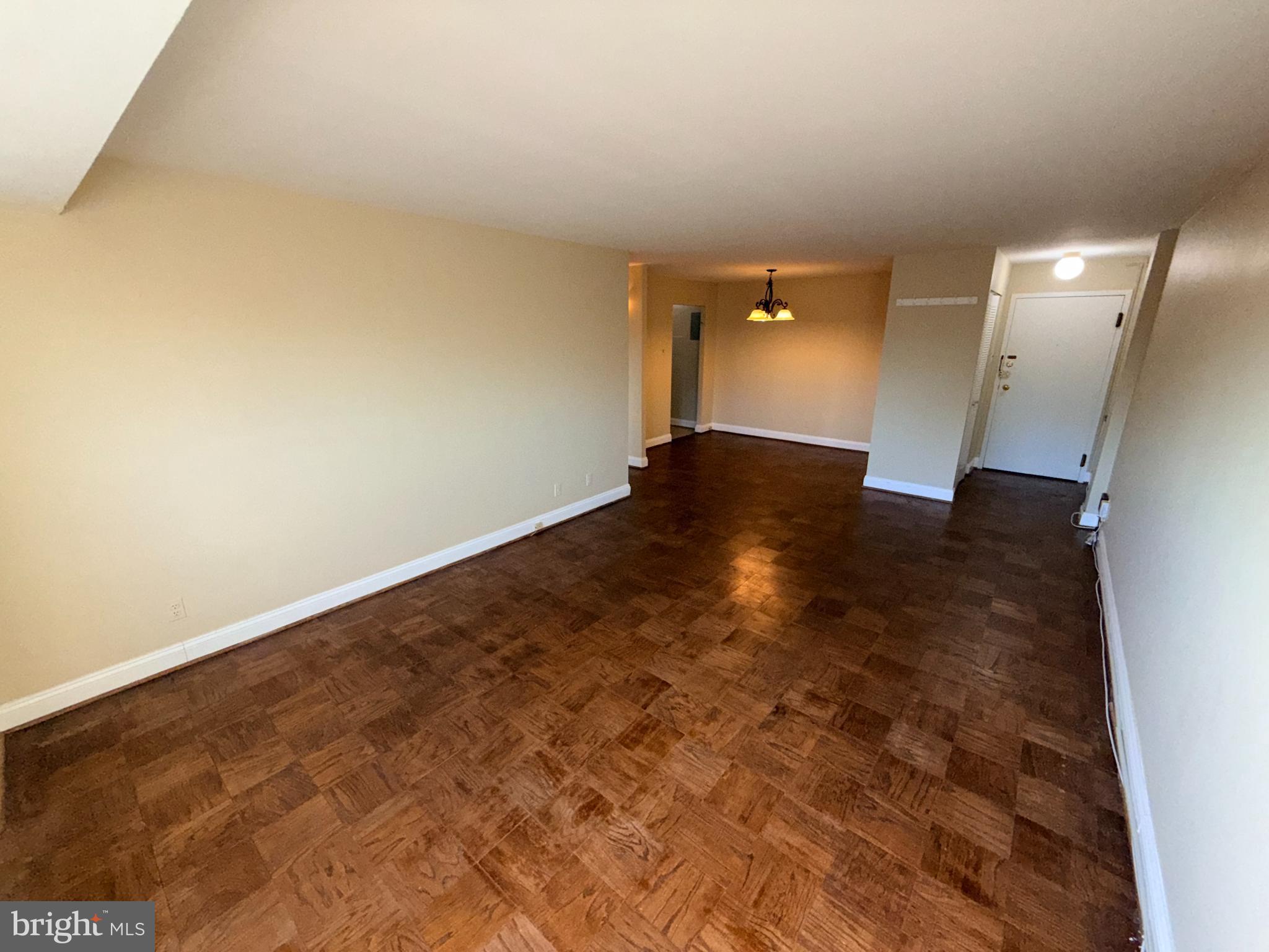 575 Thayer Avenue, Unit 703 Silver Spring, MD 20910 - Photo 3 of 9 Spacious, sunlit room with warm wood floors.