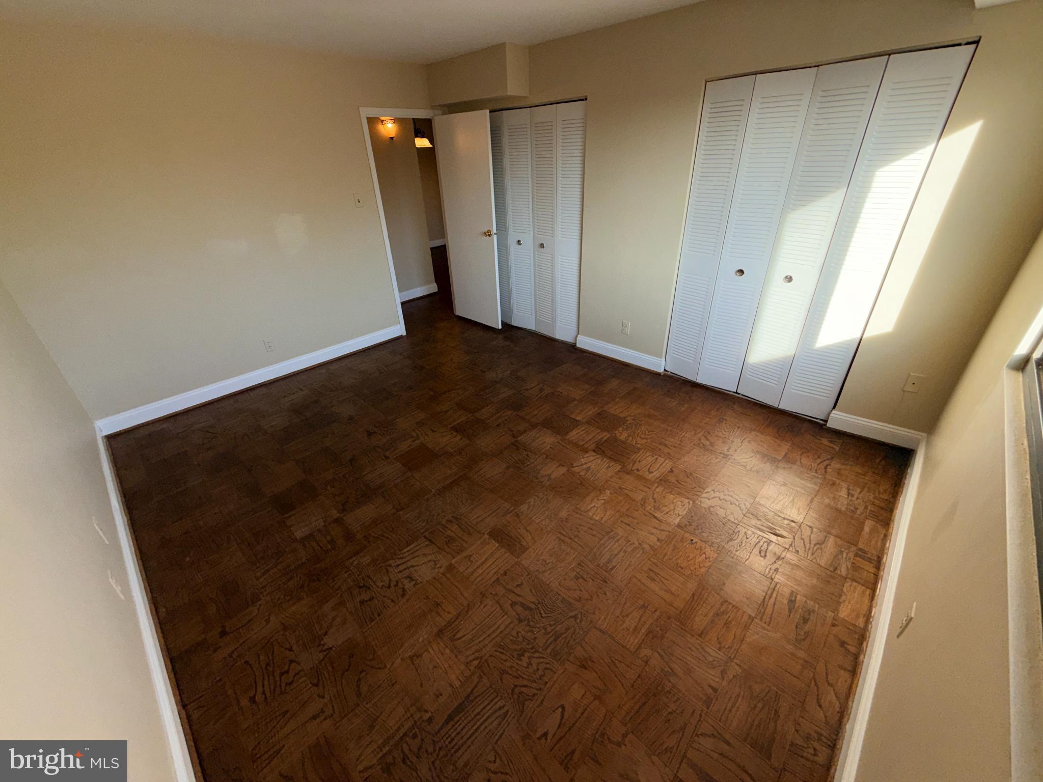 575 Thayer Avenue, Unit 703 Silver Spring, MD 20910 - Photo 7 of 9 Spacious room with warm wood flooring.
