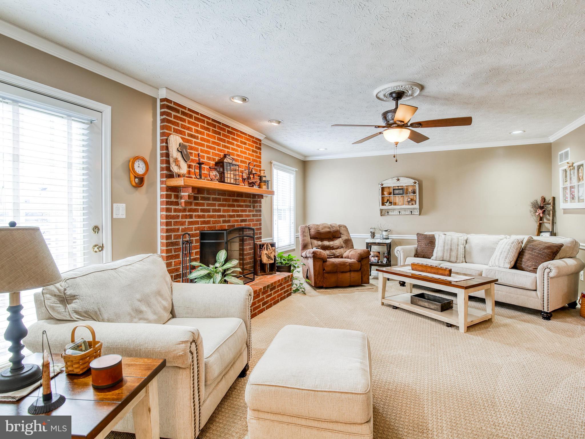 1714 Apple Pie Ridge Road Winchester, VA 22603 - Photo 12 of 44 Brick fireplace with wood mantel is wood burning