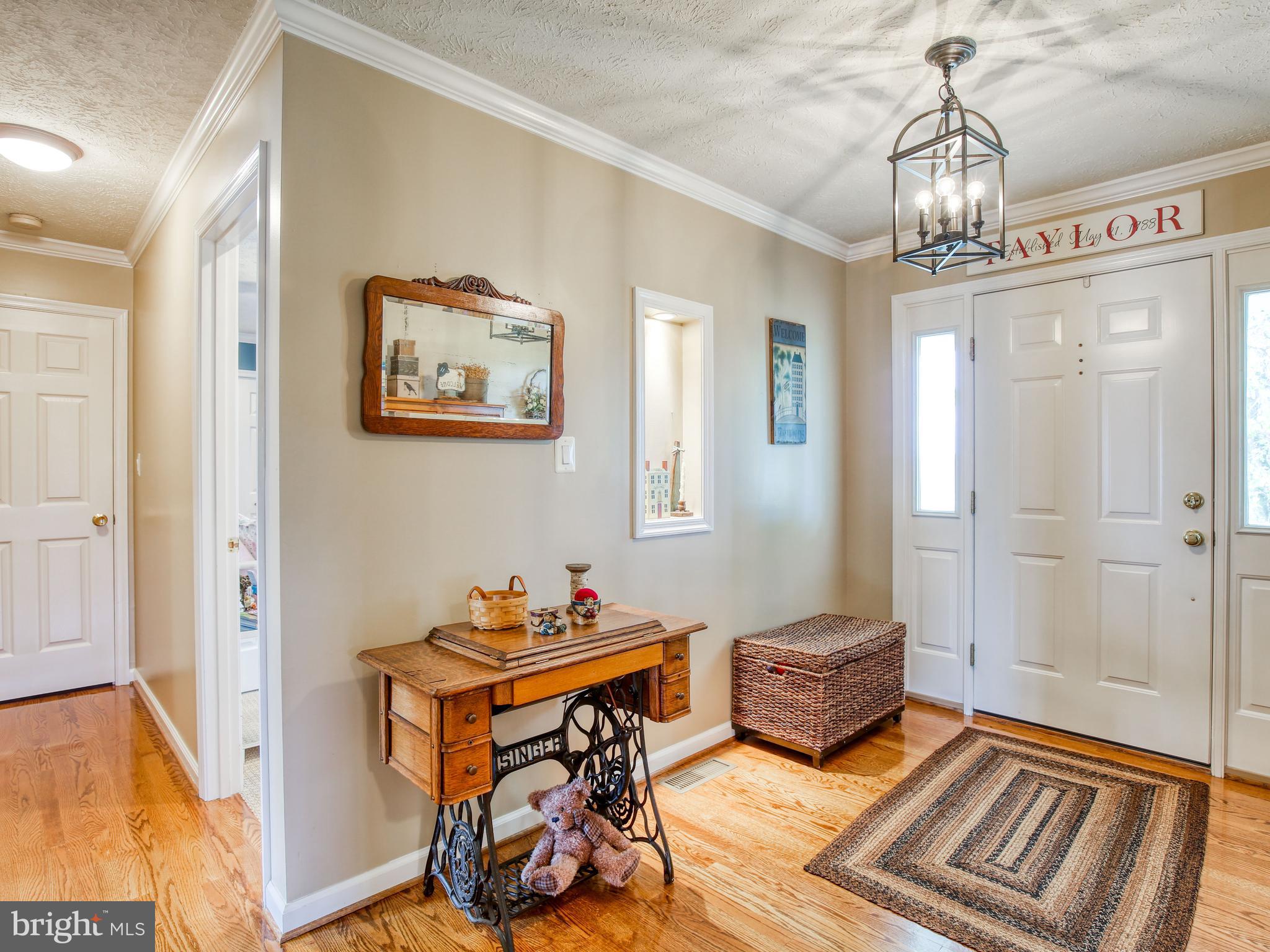 1714 Apple Pie Ridge Road Winchester, VA 22603 - Photo 10 of 44 Foyer w/wood floor, crown molding & fun lighting